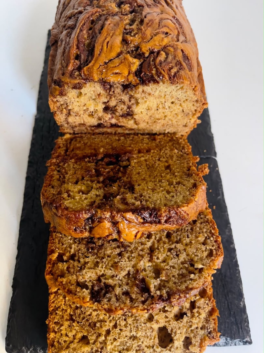 Sliced Zoaney marbled banana bread on a slate board