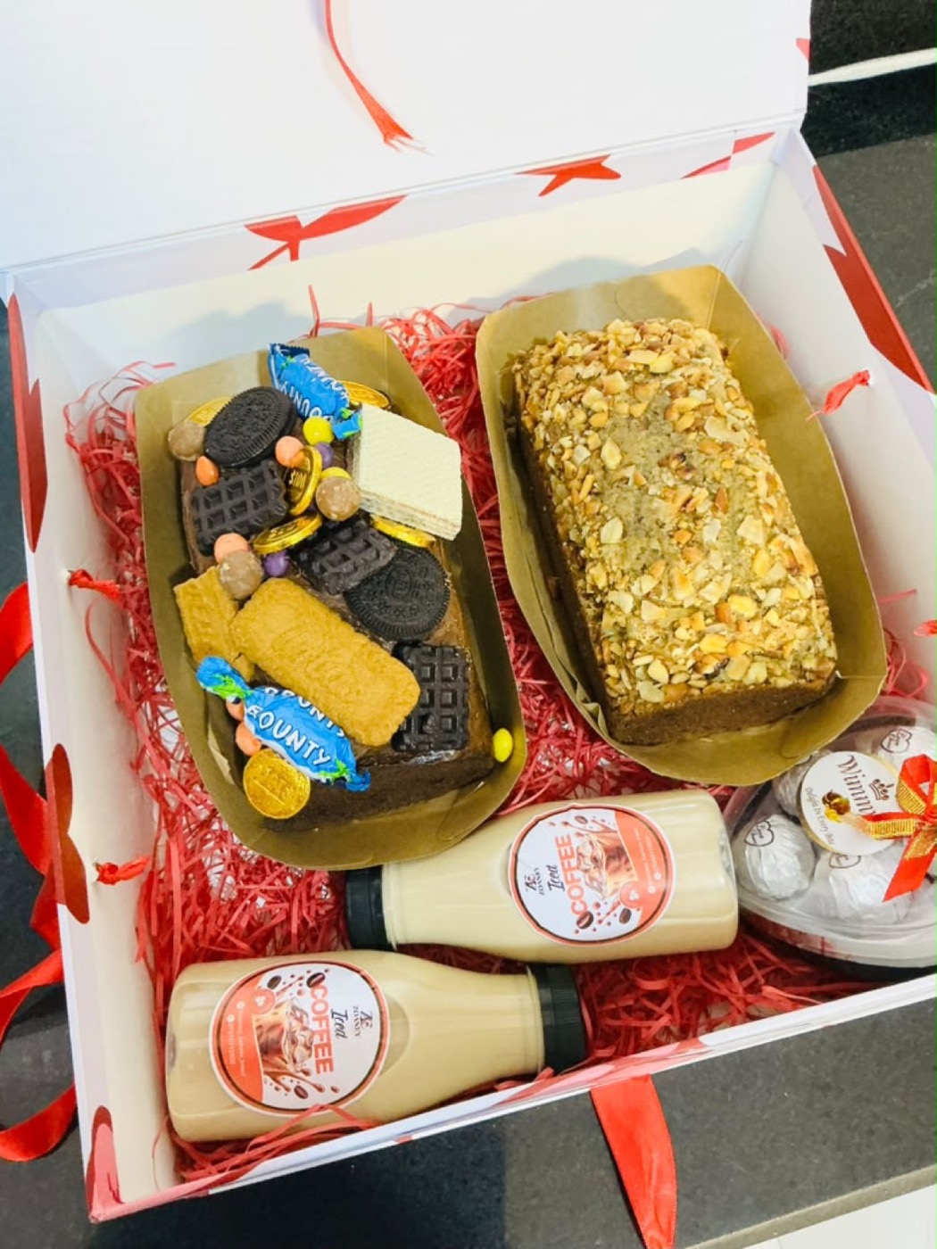 Gift hamper with banana bread, treats and bottled drinks